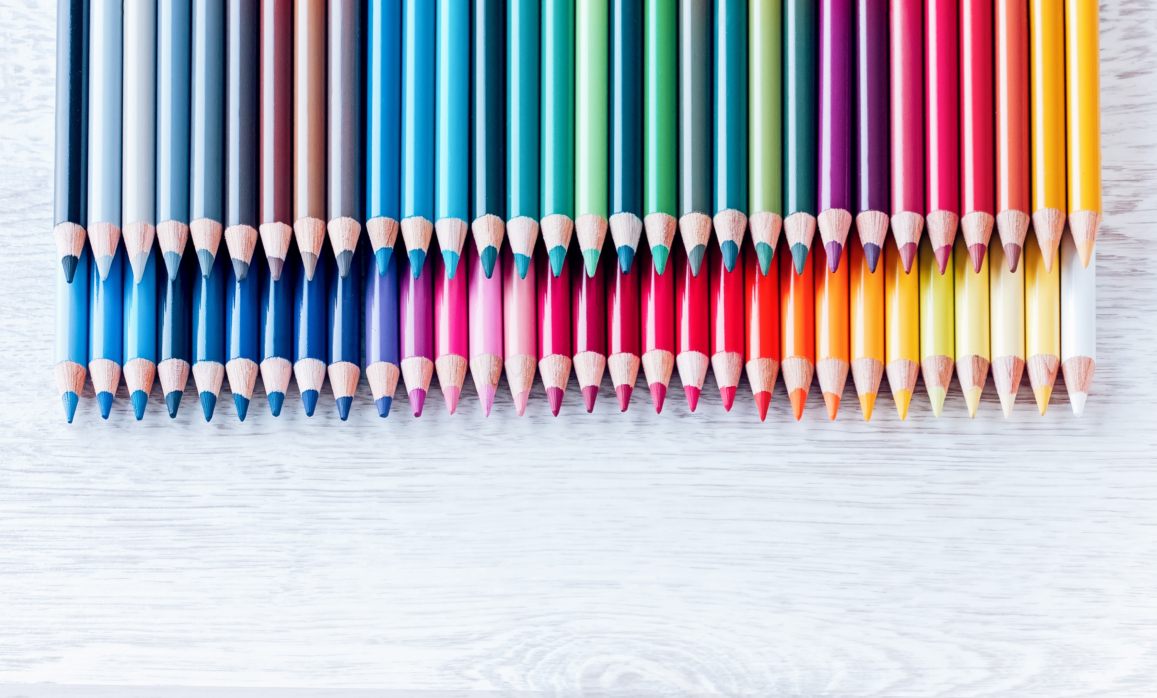 Colored Pencils On White Wooden Background