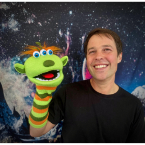 Man holding a alien puppet