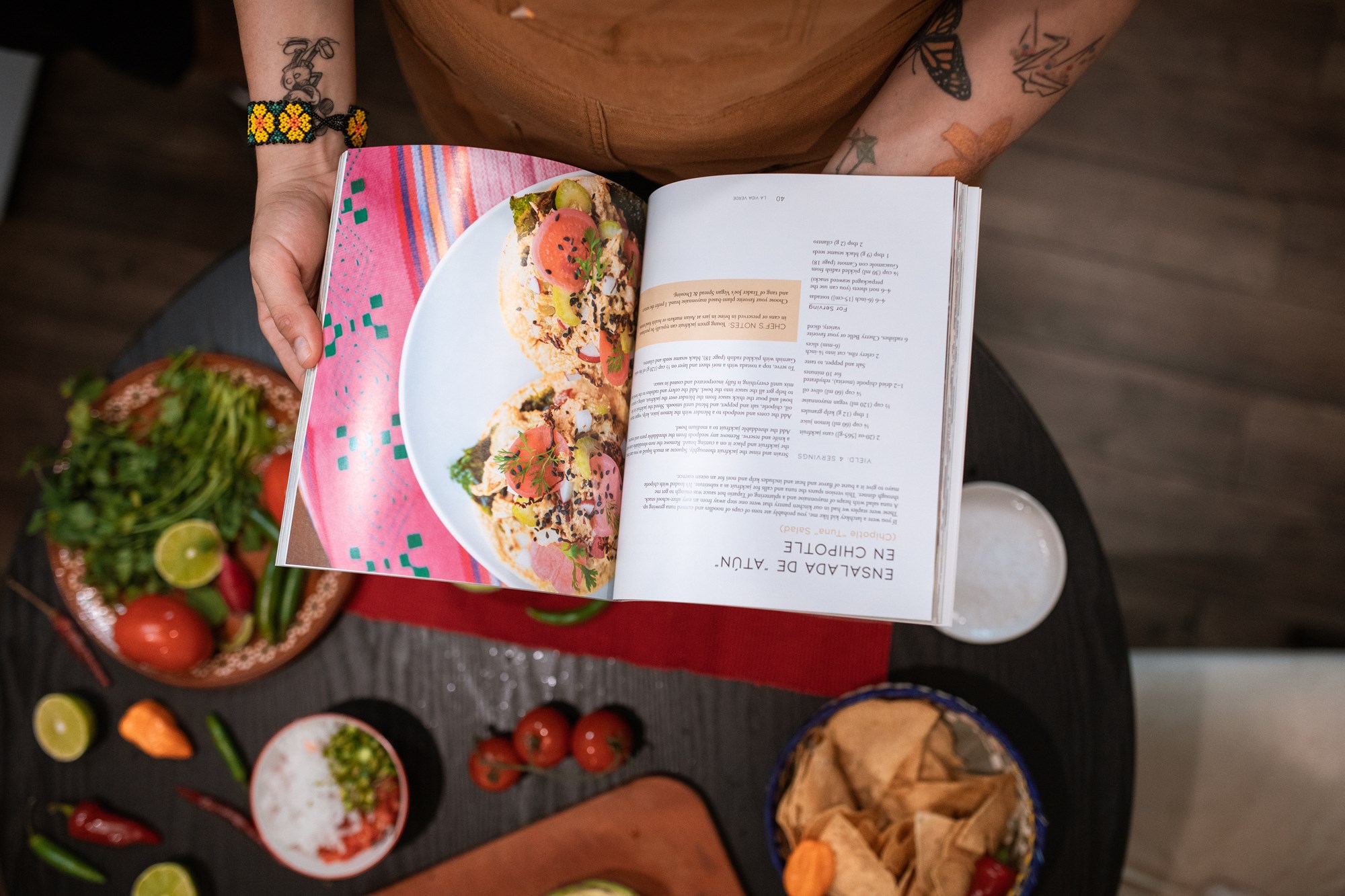 Downward View of Person Reading at Cookbook