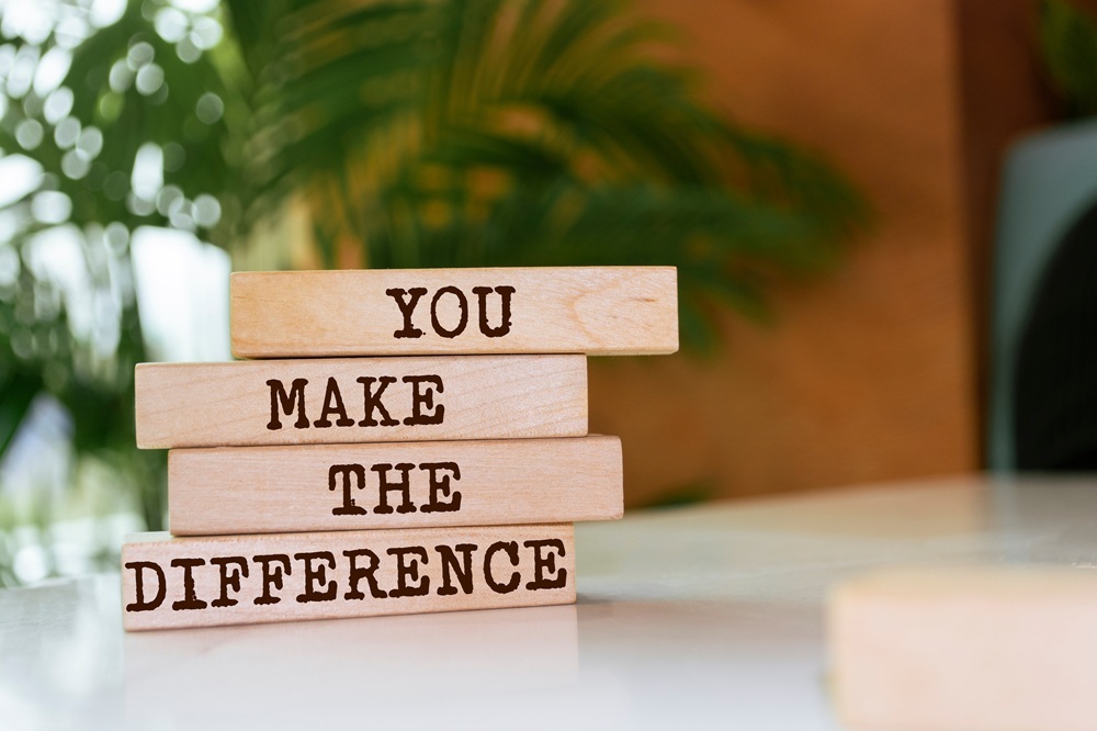 Wooden blocks spell out the words "You Make The Difference."