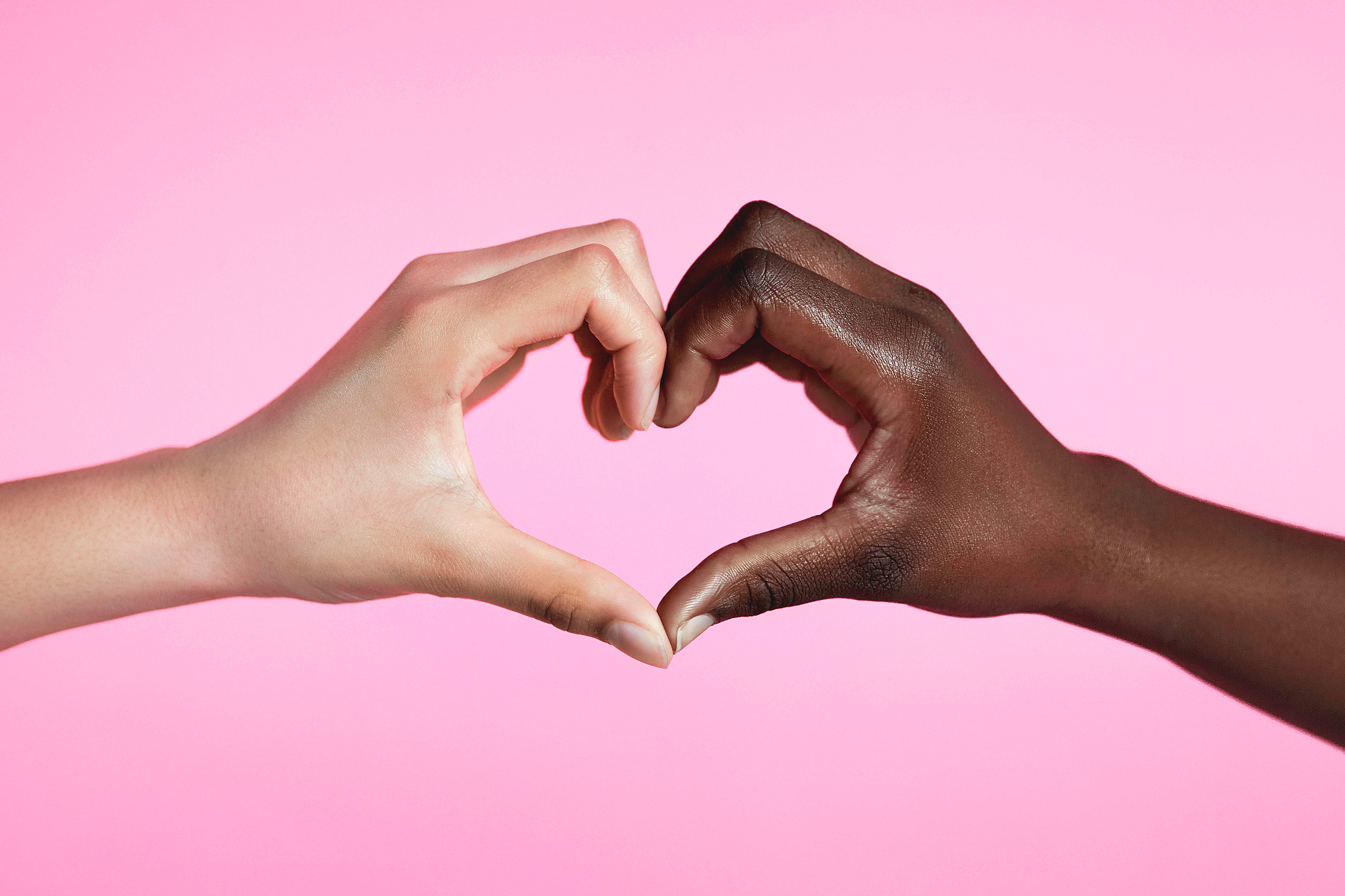 Hands with Love Sign on Pink Background