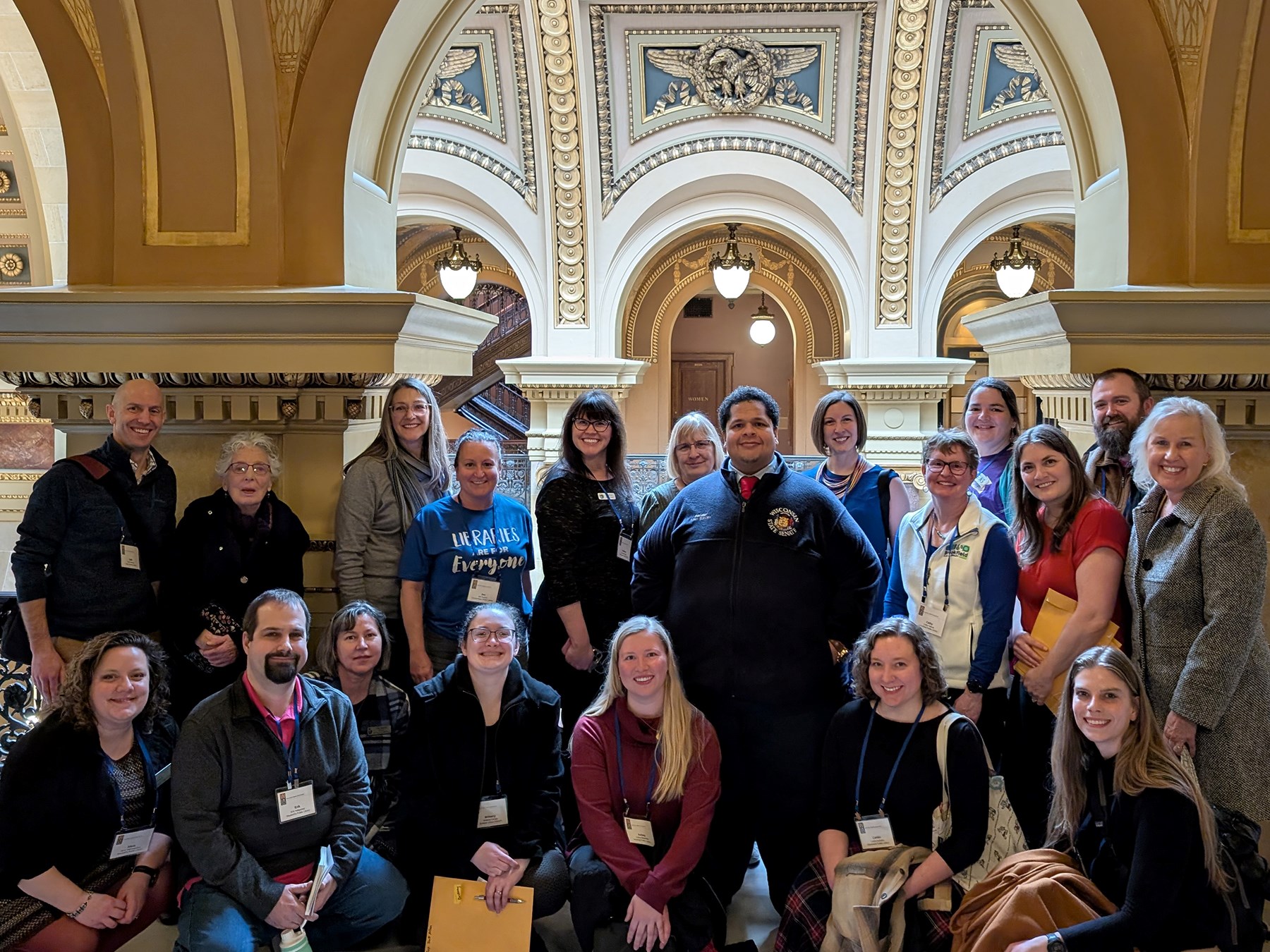 A large group of library staff and trustees with Senator Julian Bradley at the Capitol building in Madison, Wisconsin
