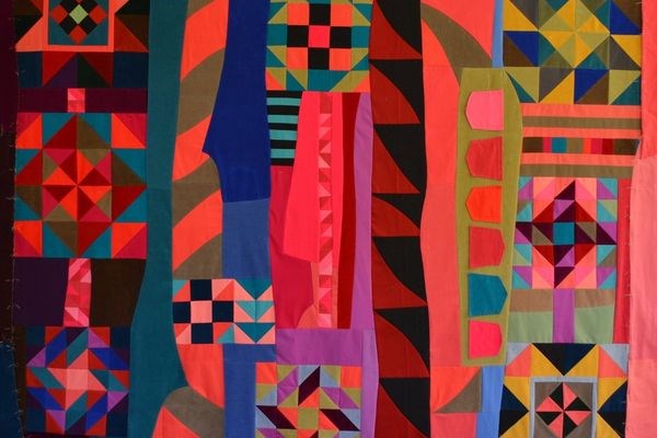 Colorful geometric quilt made of recycled clothing