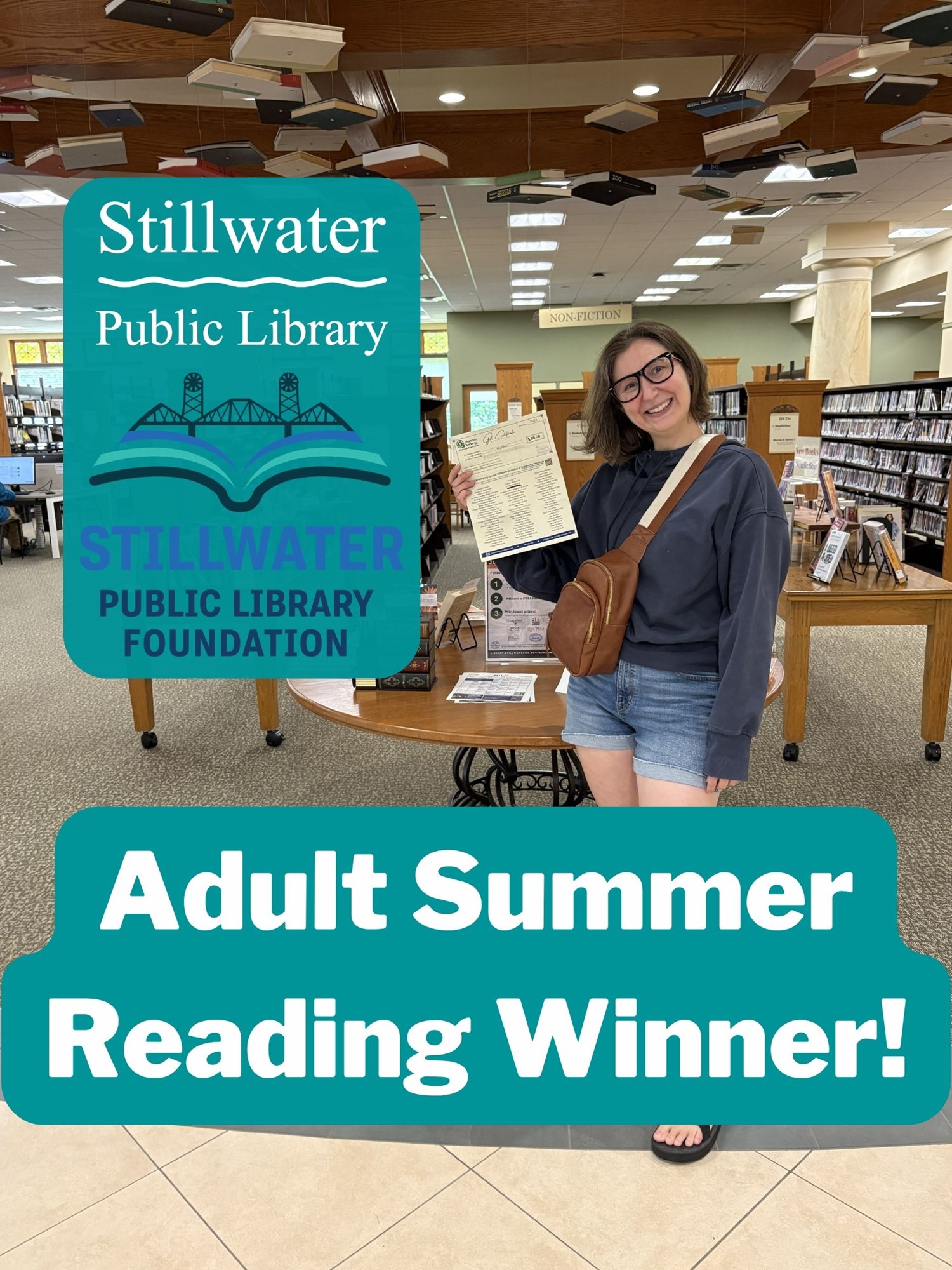 Patron posing in library with her gift certificate