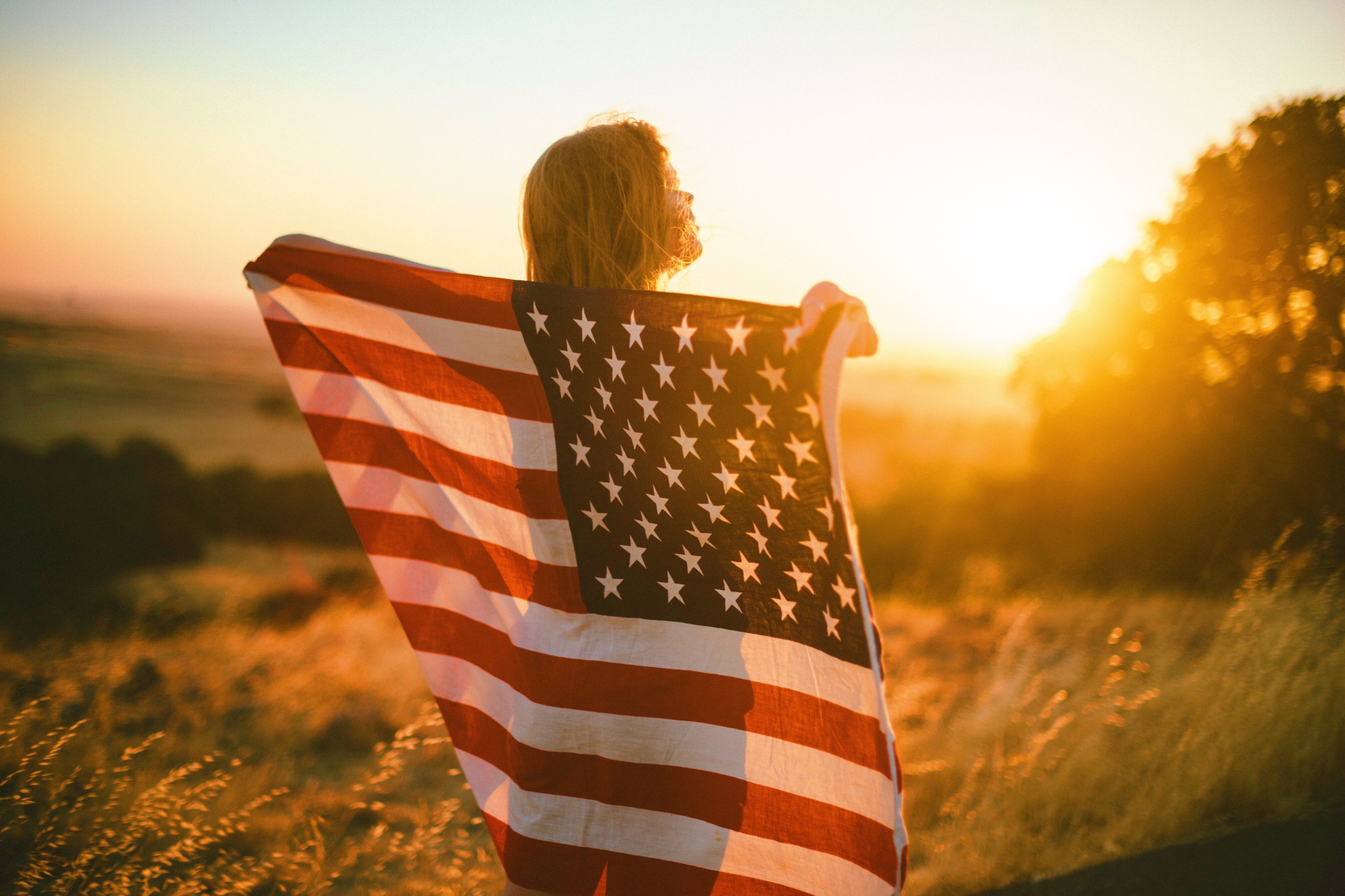 woman holding up American flag