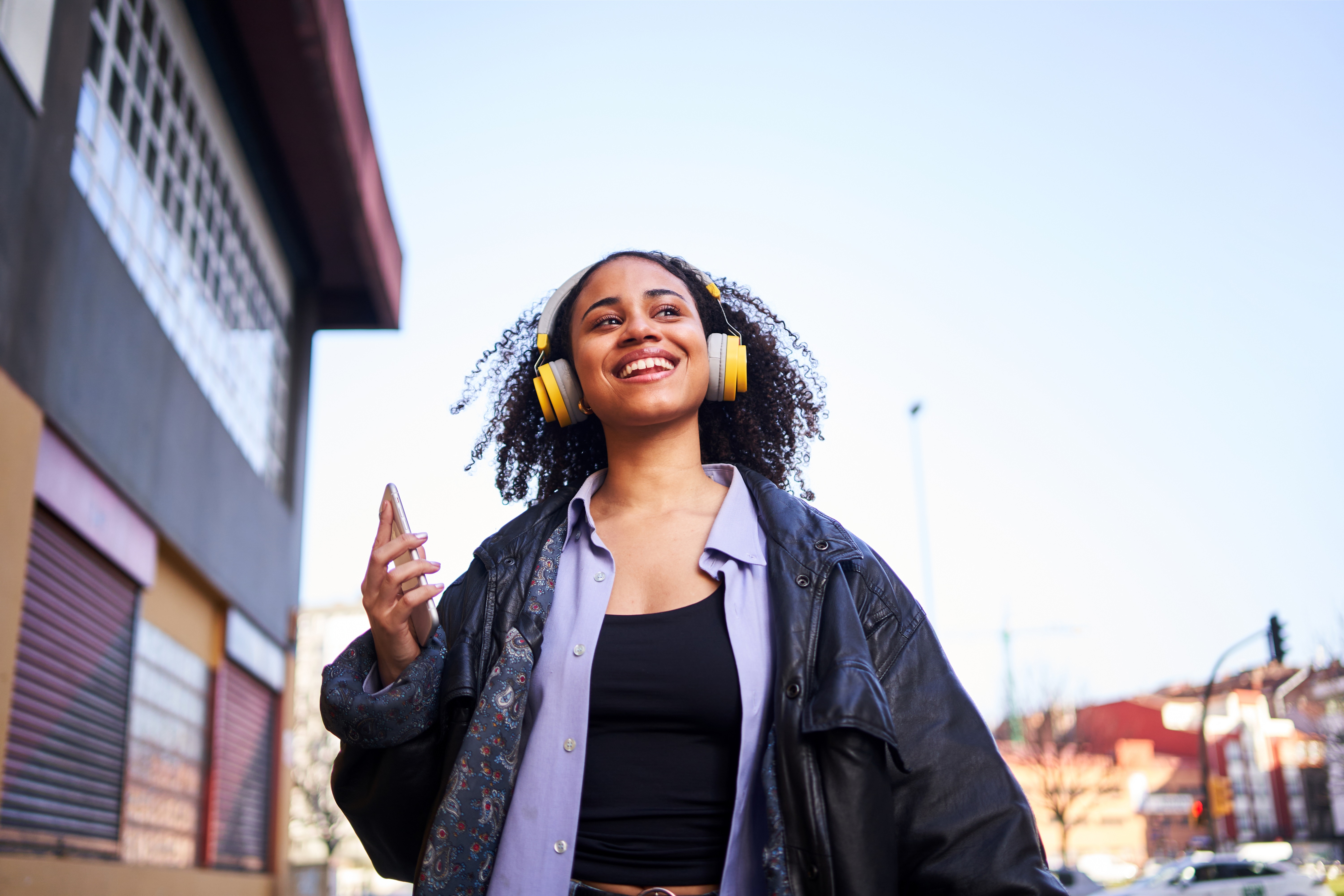 Cheerful Woman Listening to Music with a Mobile Outdoors