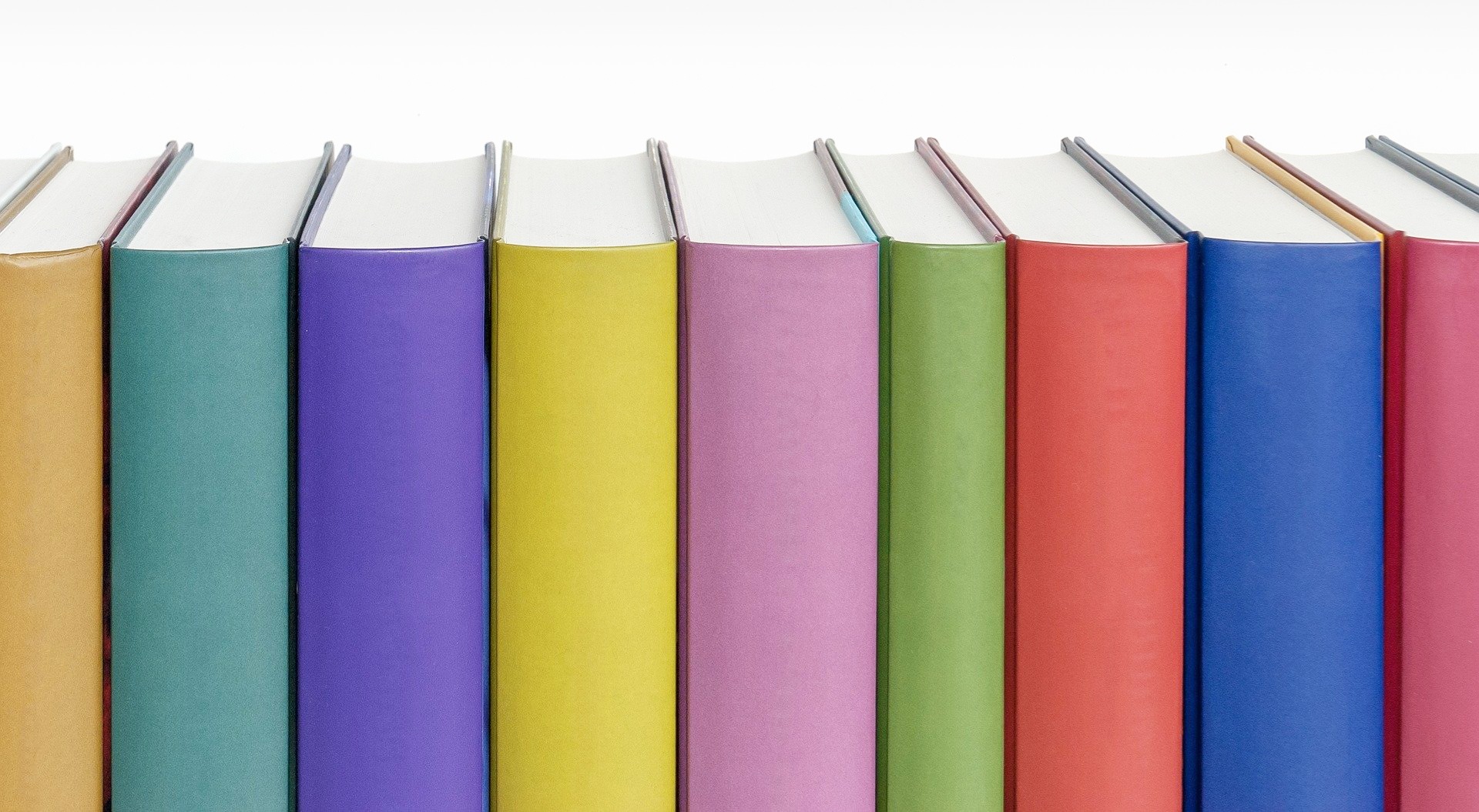 Multi-colored book spines in a row