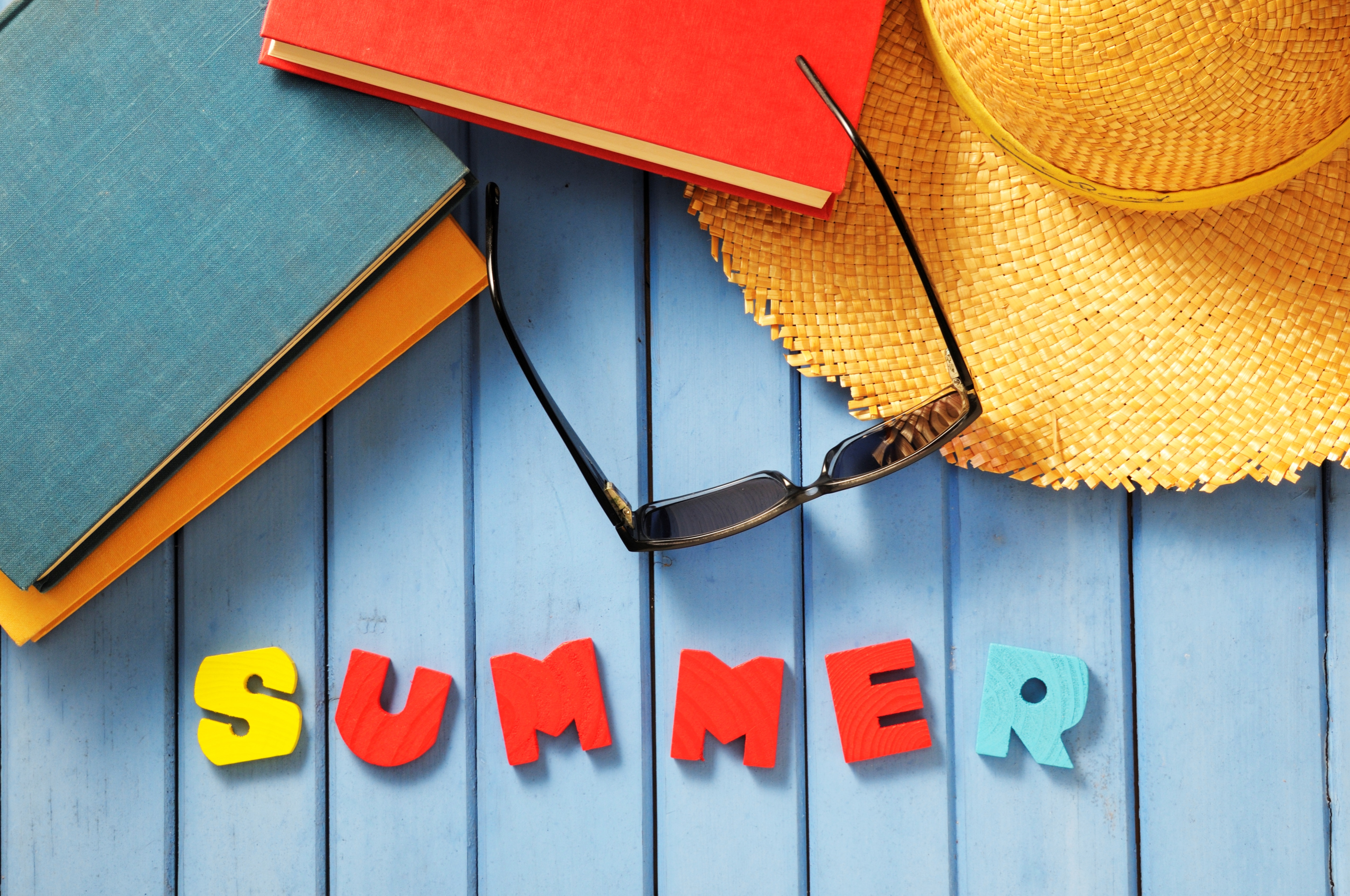 Summer Reading Letters with Colorful Books and Straw Hat Sunglasses