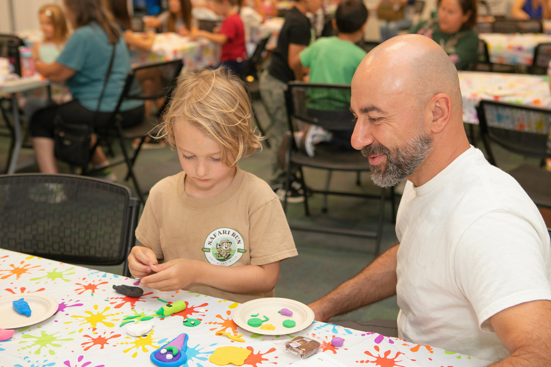 Parent and child participating in a craft.