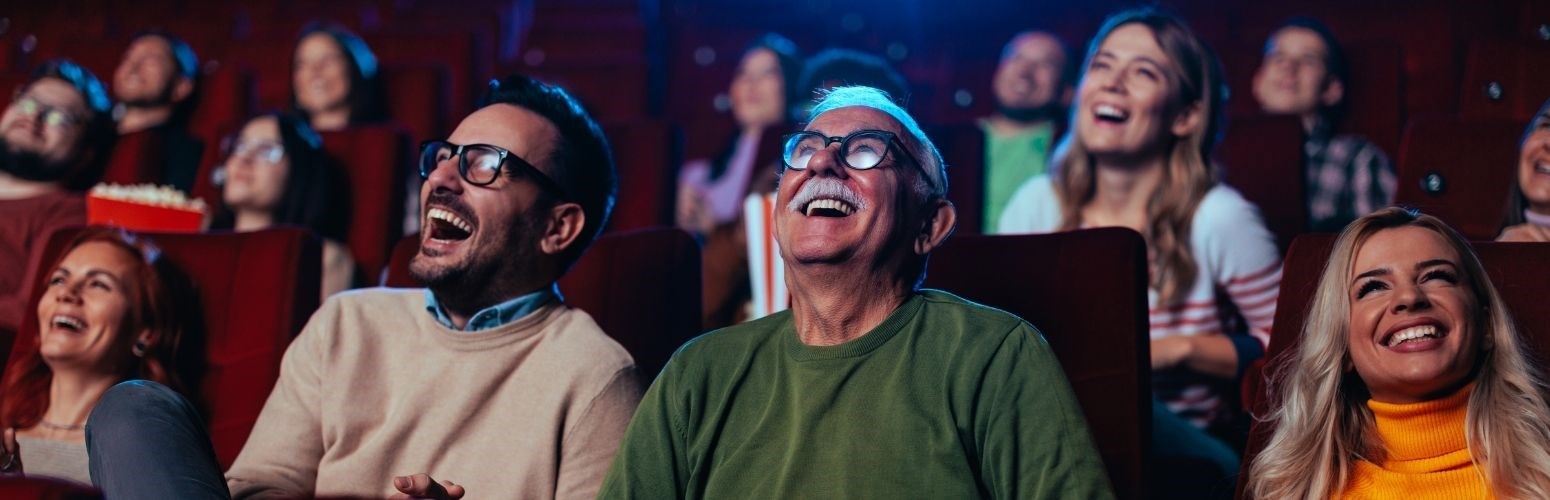 Crowd of people in a theater looking out into the distance, as if watching a movie. Crowd of people in a theater looking out into the distance, as if watching a movie.