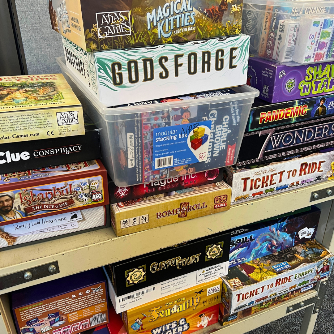 A variety of board games stacked.
