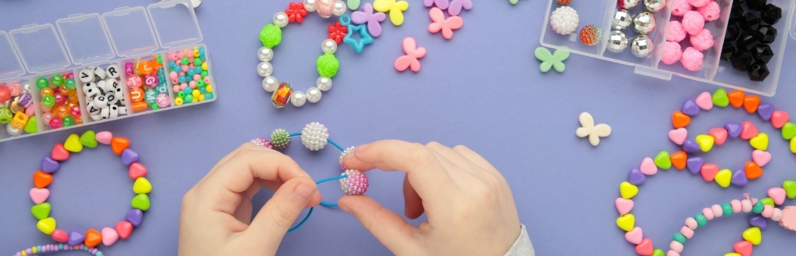 Hands making a friendship bracelet. Hands making a friendship bracelet.