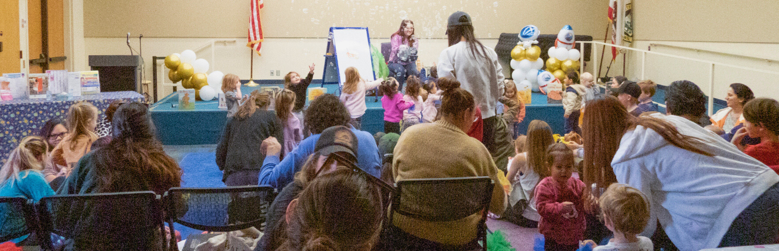 Children and parents in the Community Room for a special program. Children and parents in the Community Room for a special program.