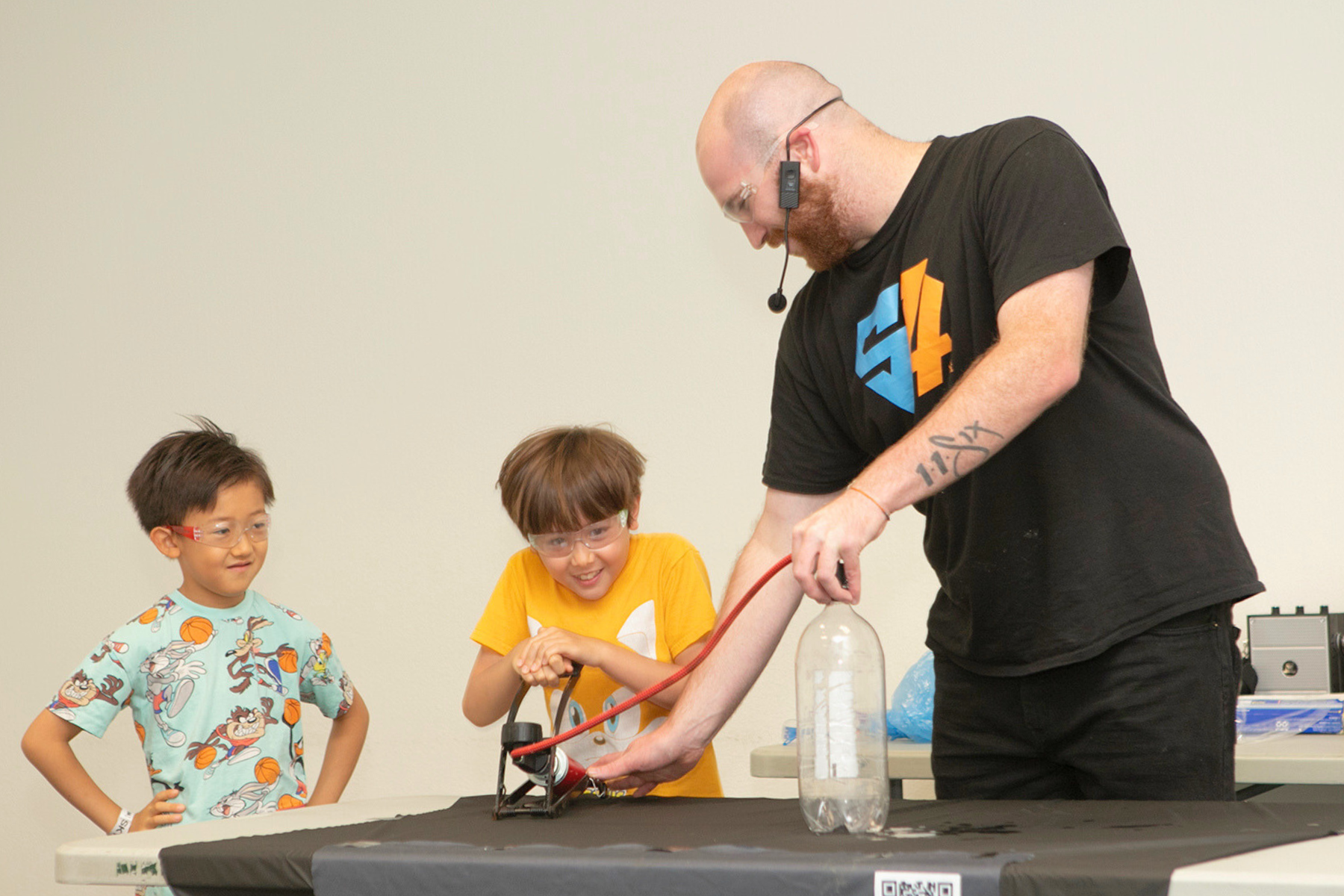 Two children participating at a magic show for summer reading club.