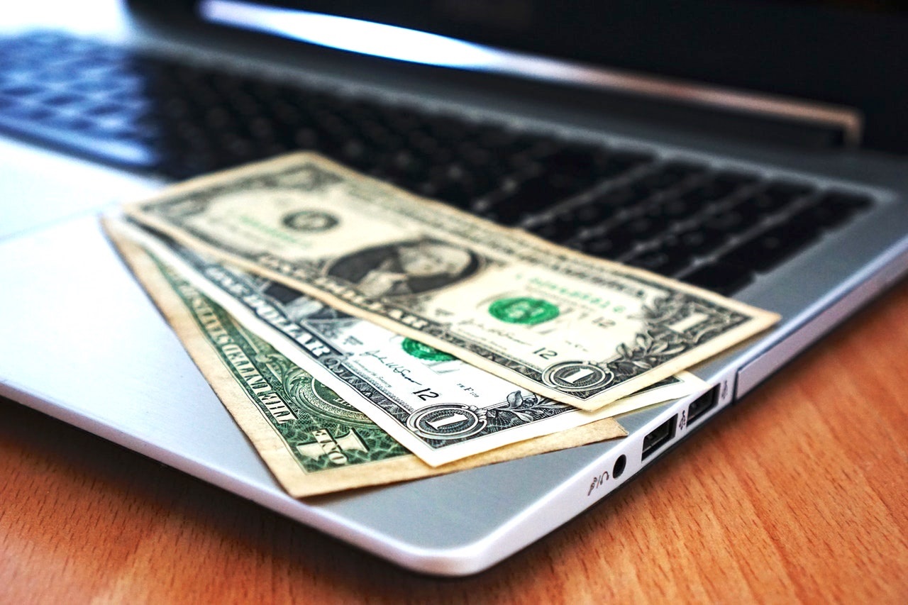 Computer laptop money cash online shopping spending savings debt