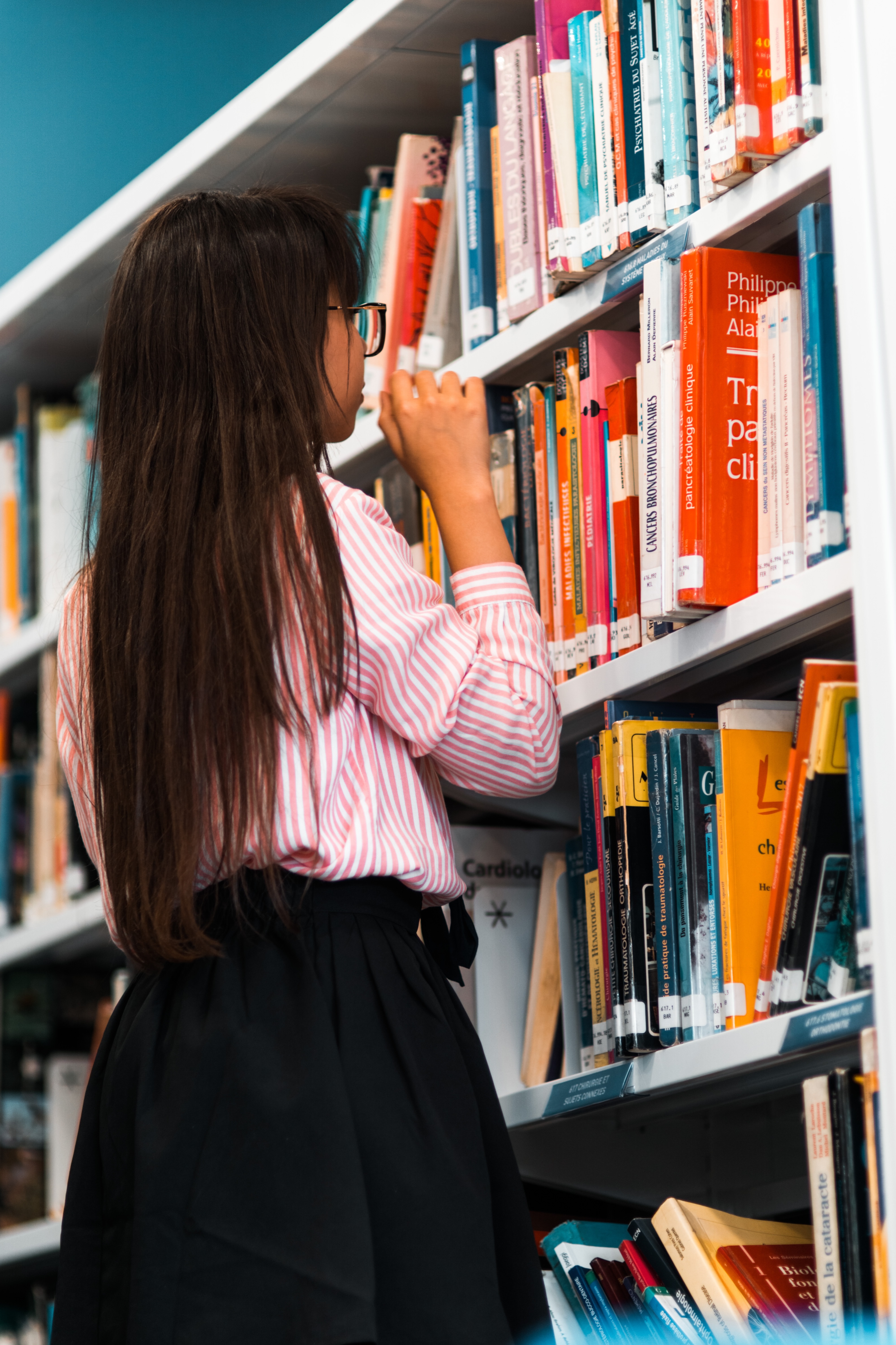 Female Searching Bookshelves