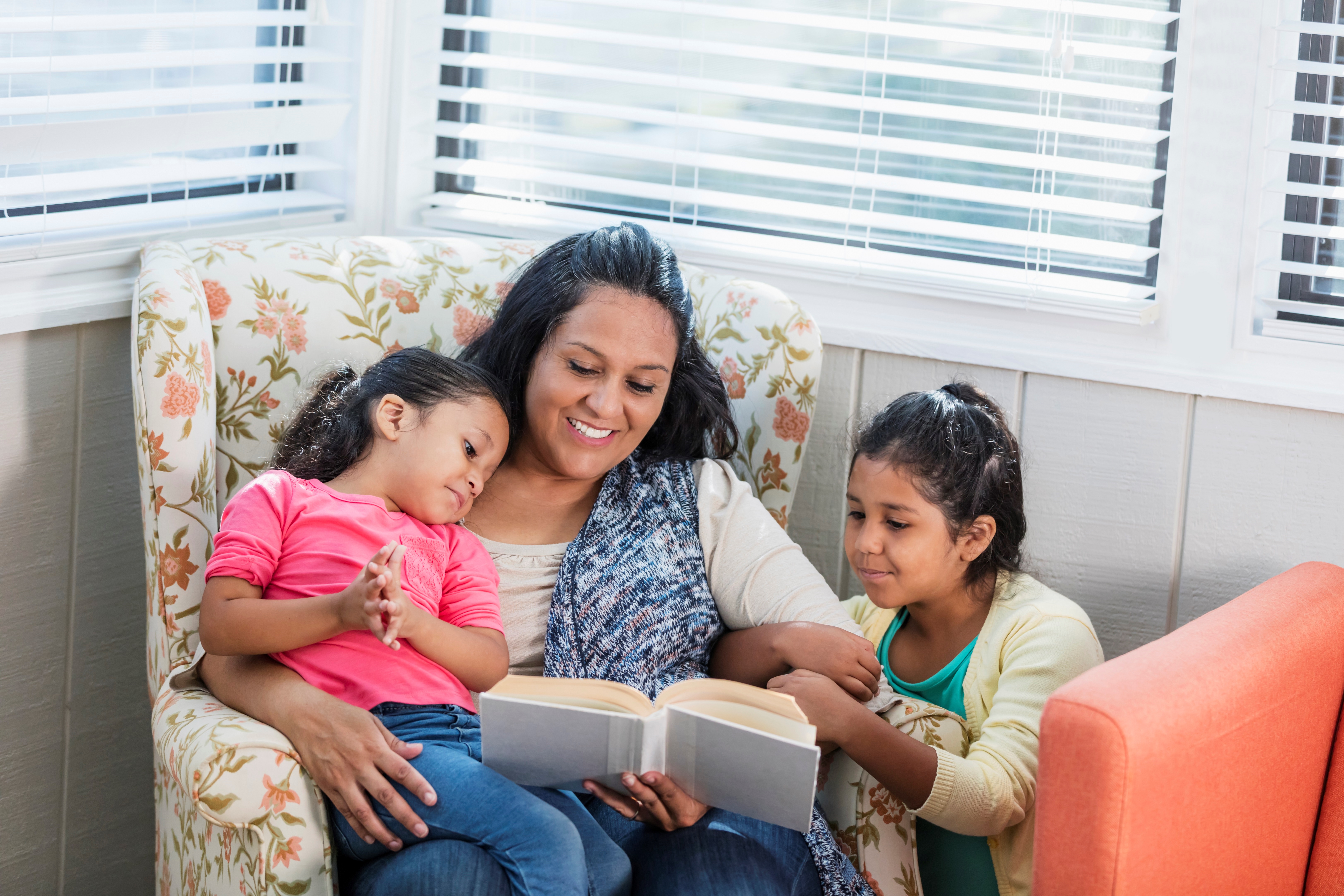 Mother Reading To Her Two Daughters