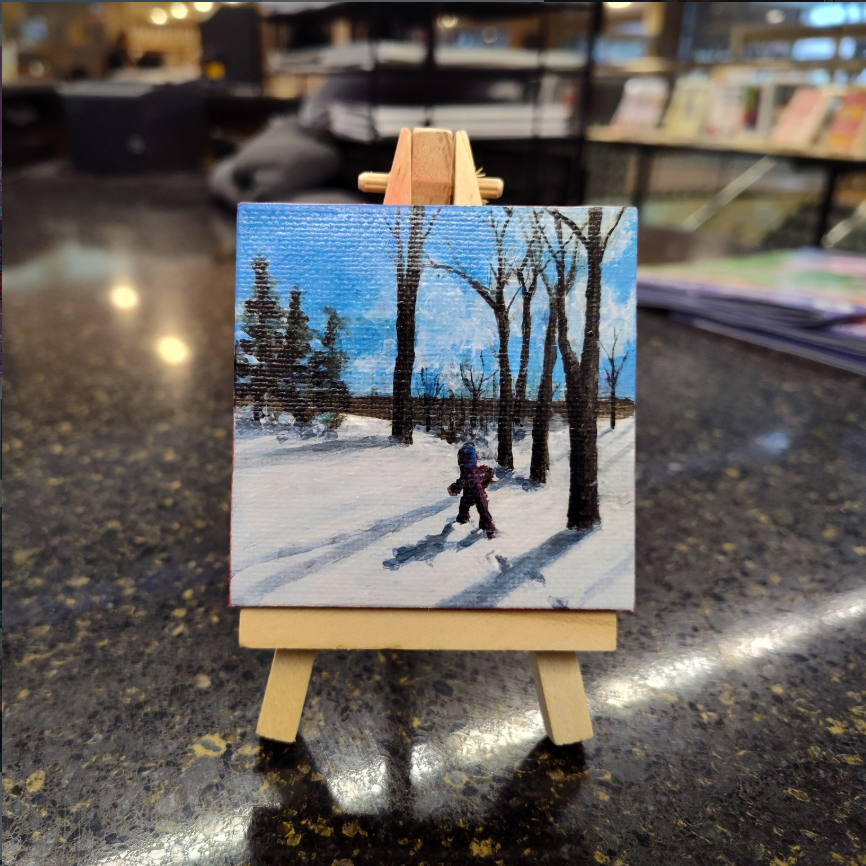 The 2025 Tiny Art Show Winner, a painting of a child walking through the snow, leaving behind small footprints