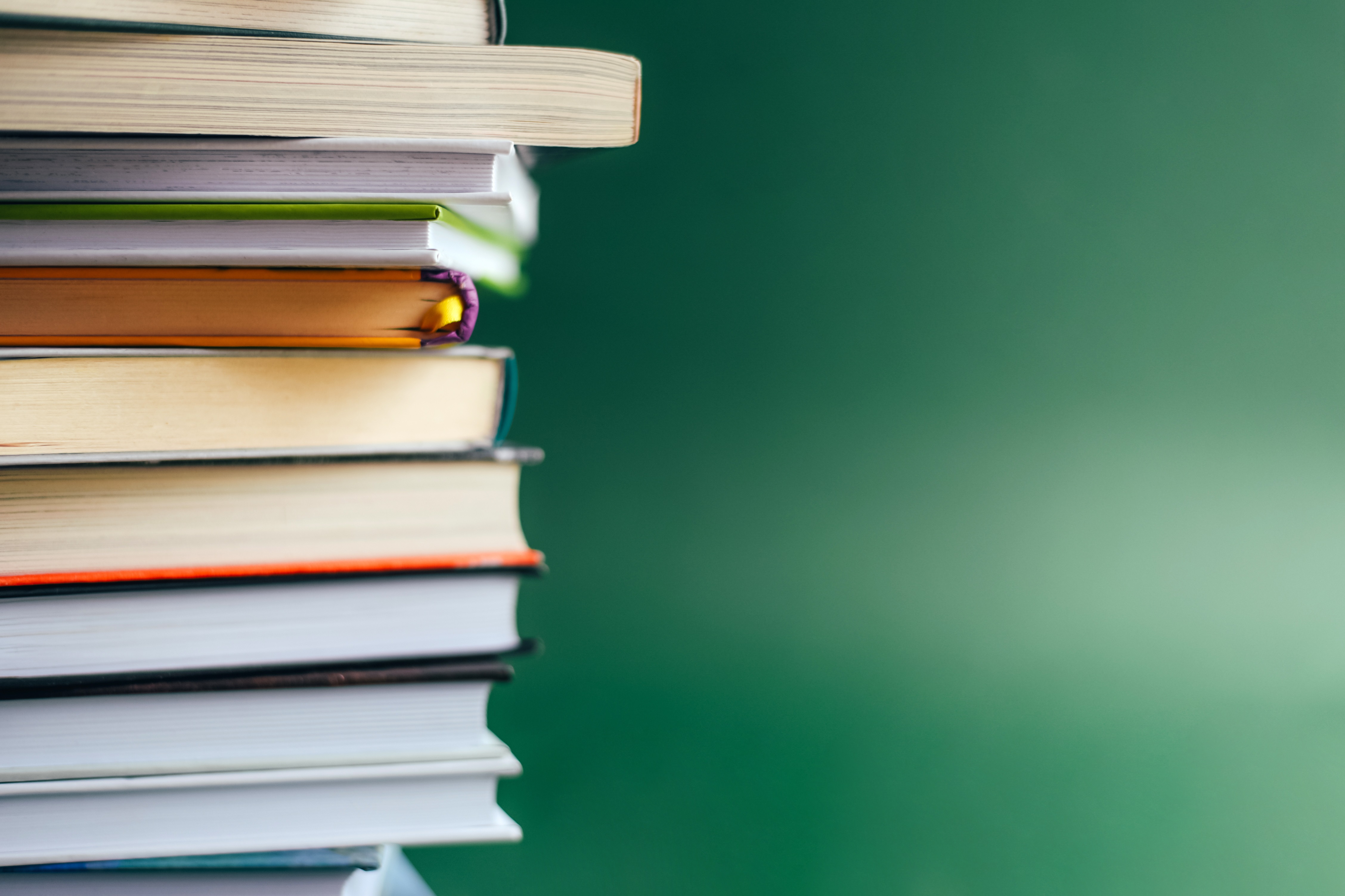 Stack of Books on a Green Background