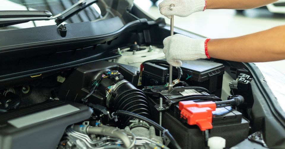 Person repairing a car engine.