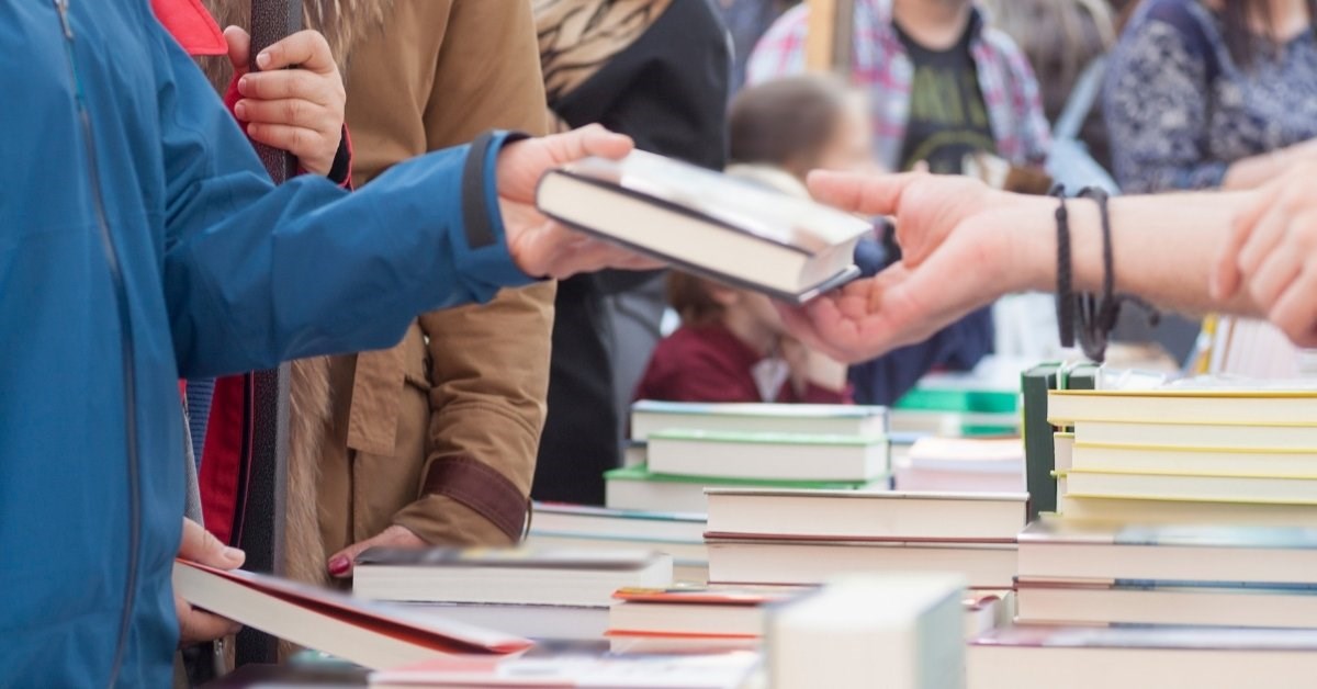Person selling a book.