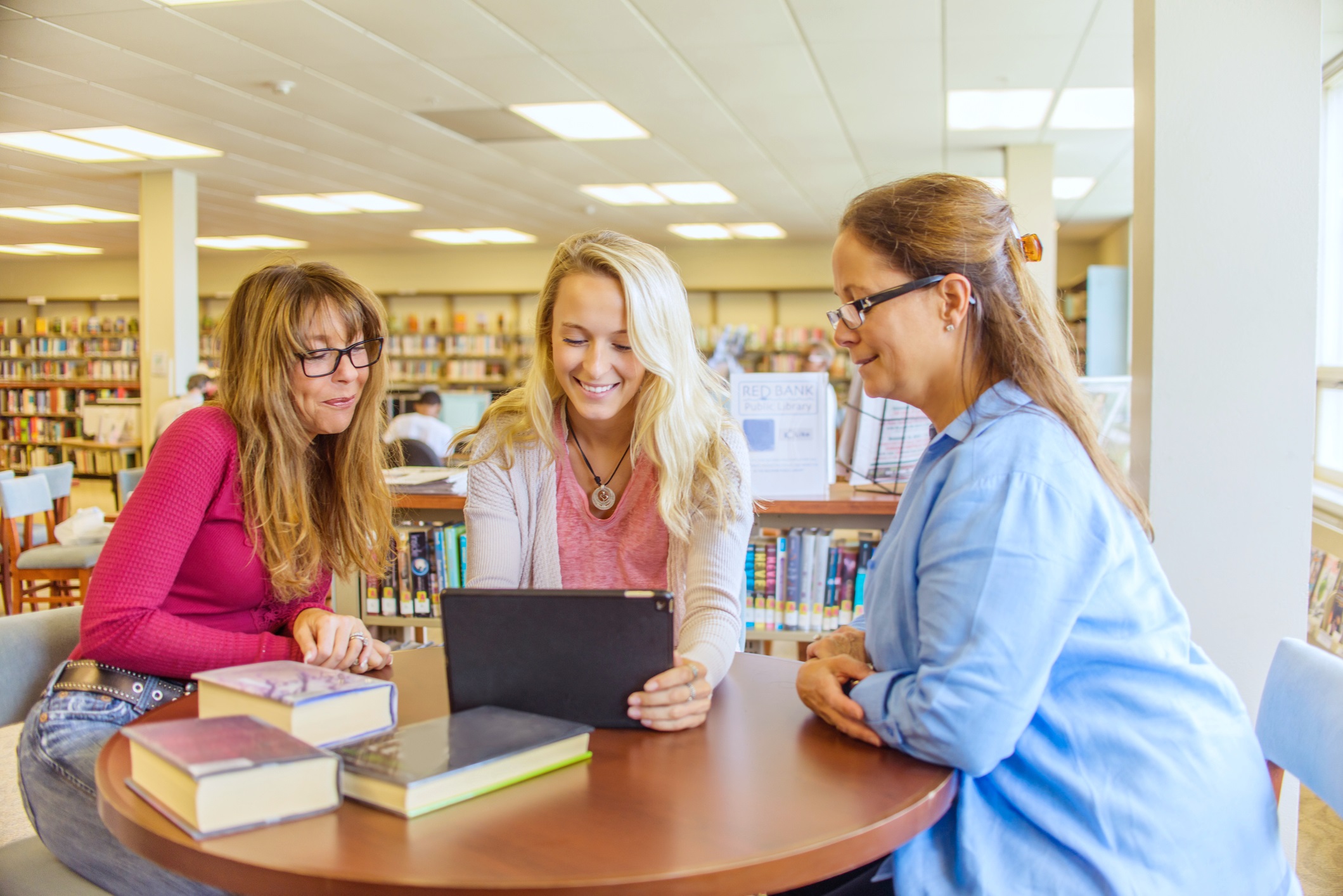 Three Women Meeting in the Library