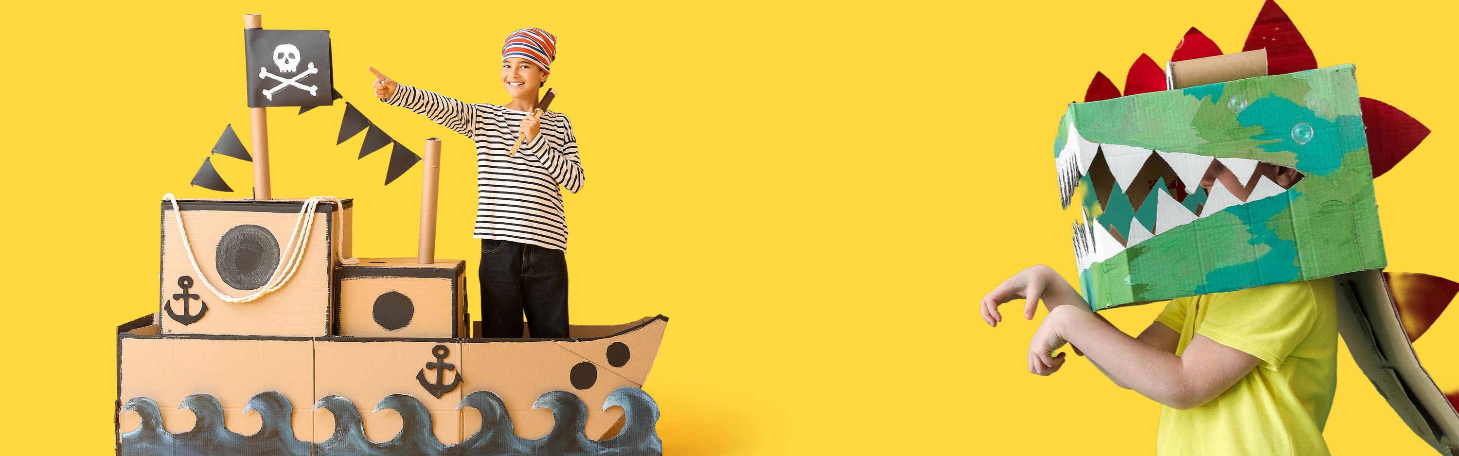 Children playing pretend with cardboard creations. 