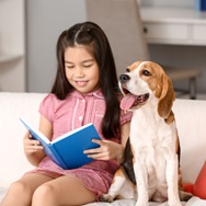 Child reading to a dog