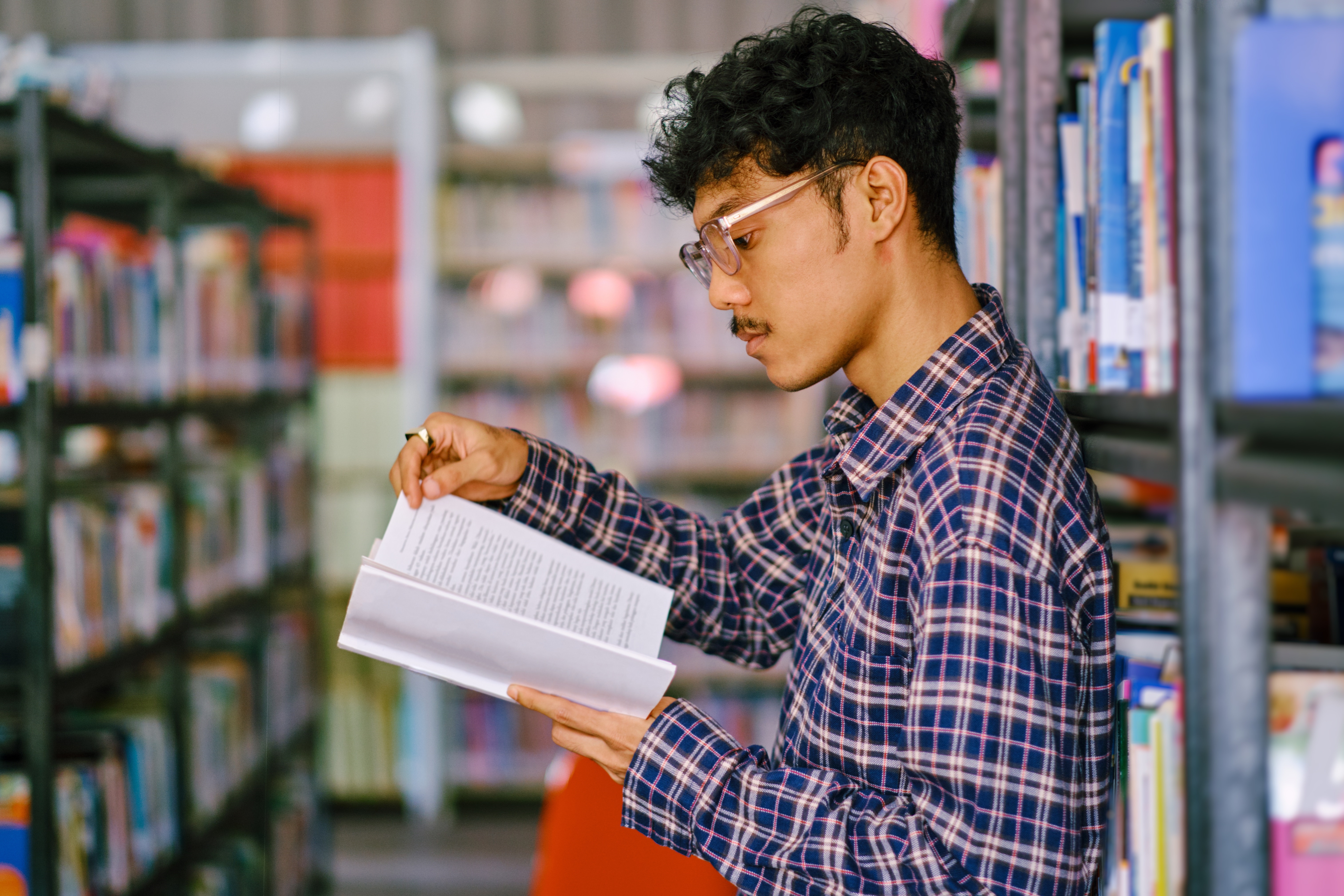 Young Man Reading in the Library