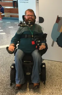Man using a mobility device posing for a picture