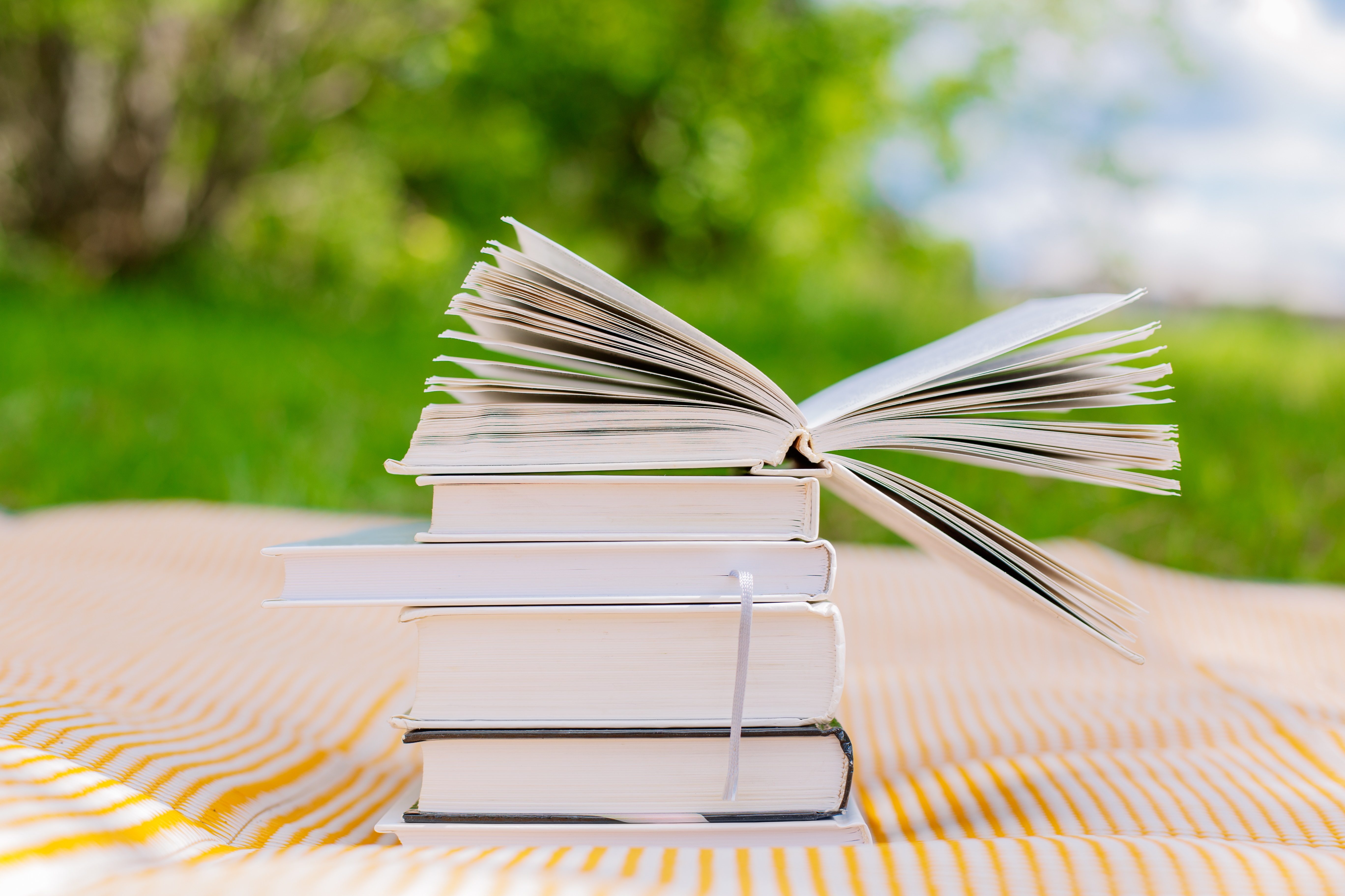 Pile of Books with One Opened Book