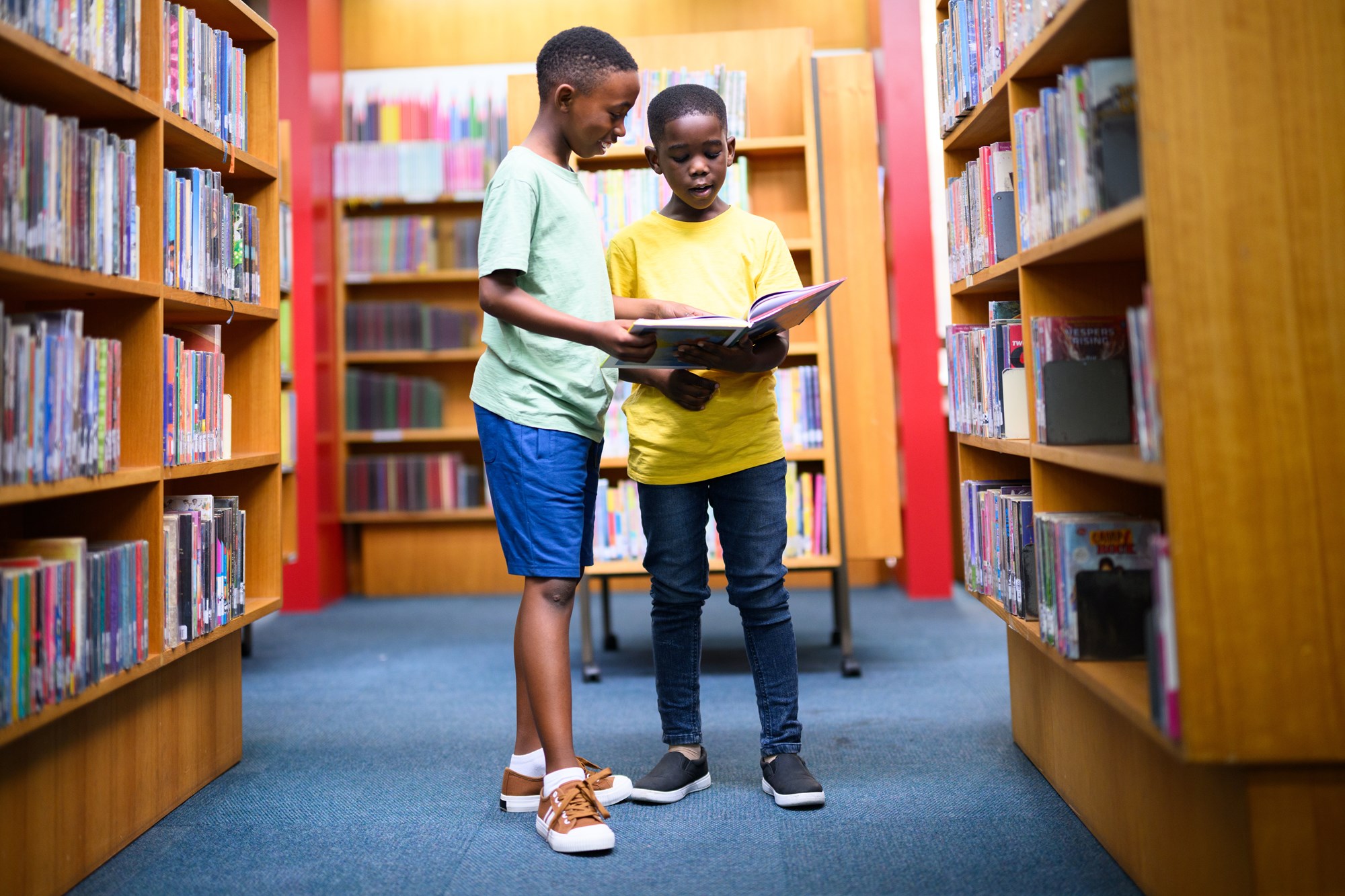 two girls in library reading two girls in library reading