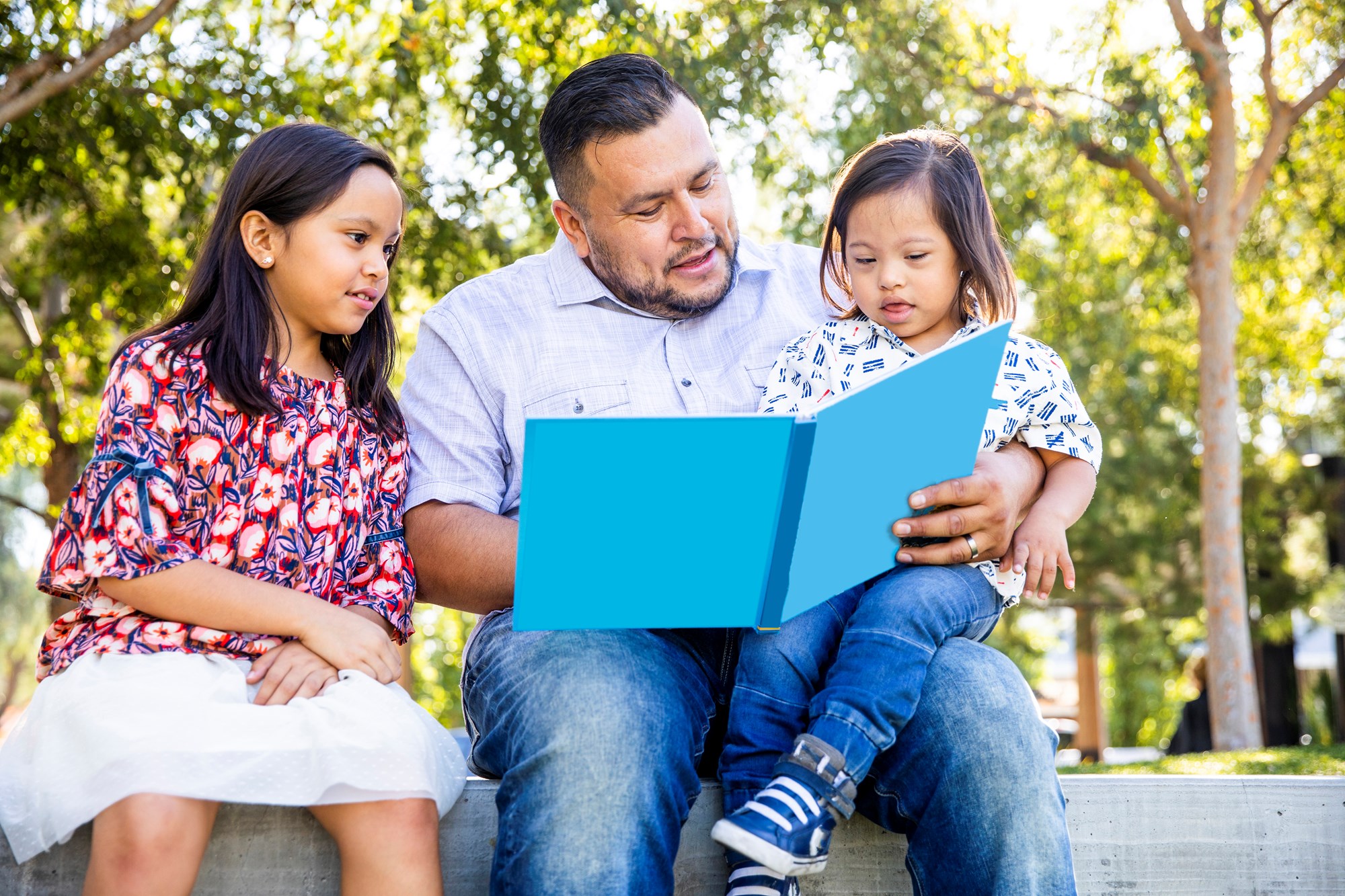Man Reading Blue Book with Children
