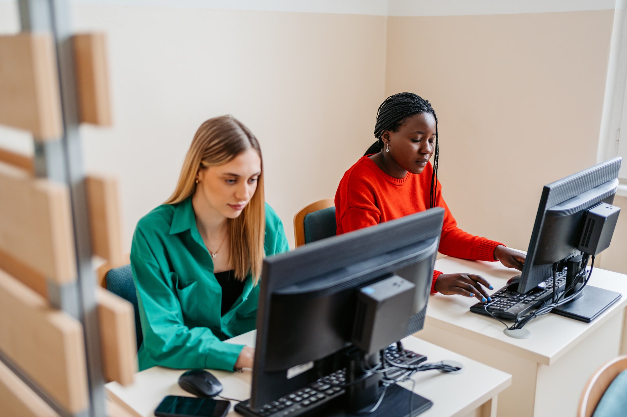 two girls in library reading