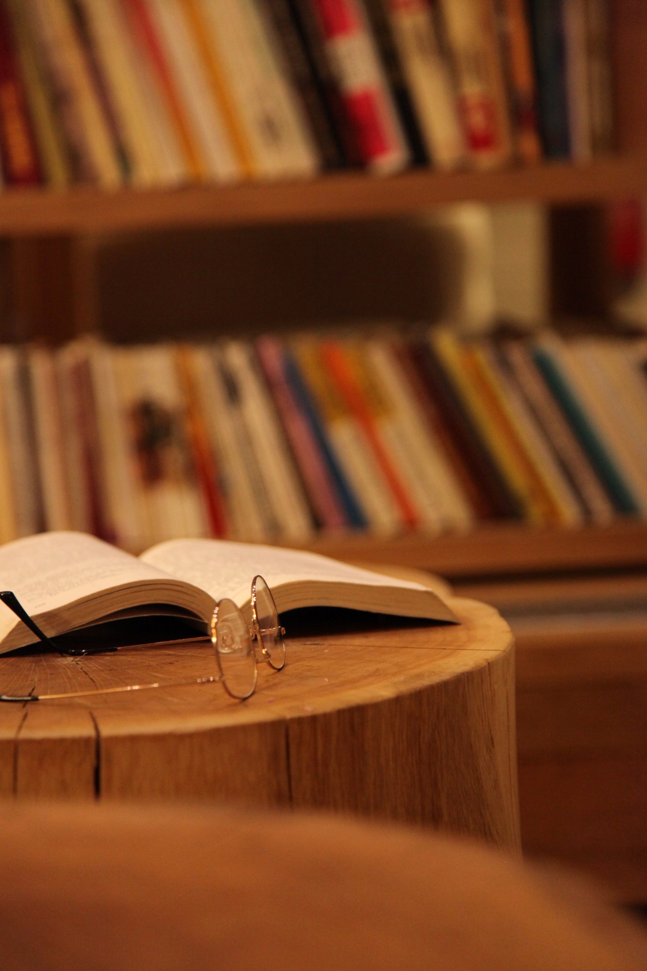 A Book with Eyeglasses on a Table in Library