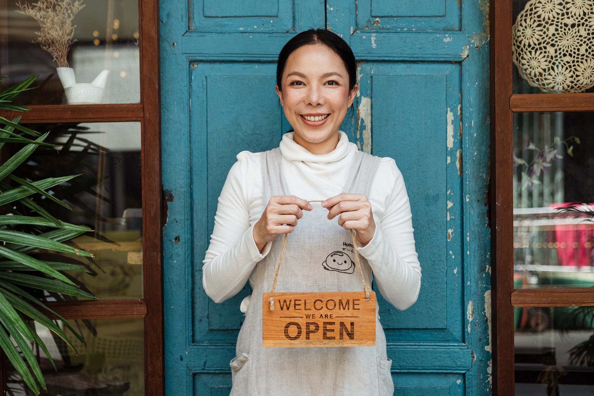 Small Business Owner with Welcome Sign