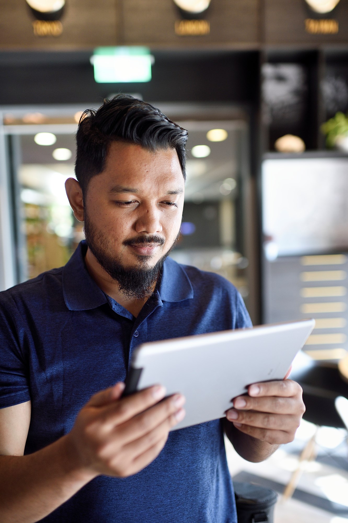 Malay Man Looking at Digital Tablet