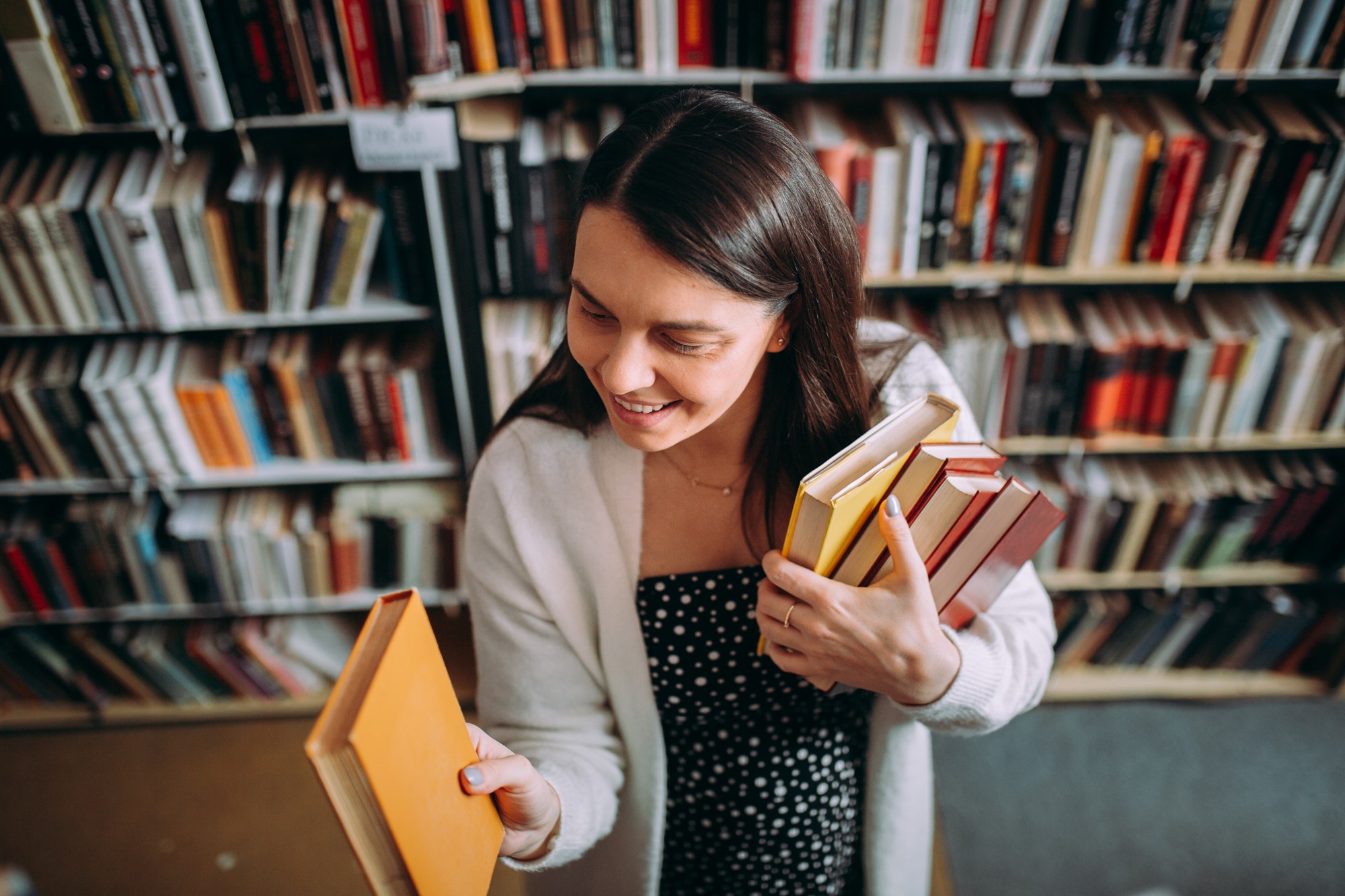 Librarian Arranging Books on Bookshelves