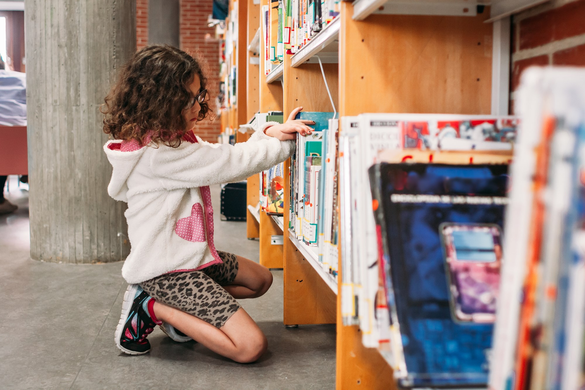 two girls in library reading