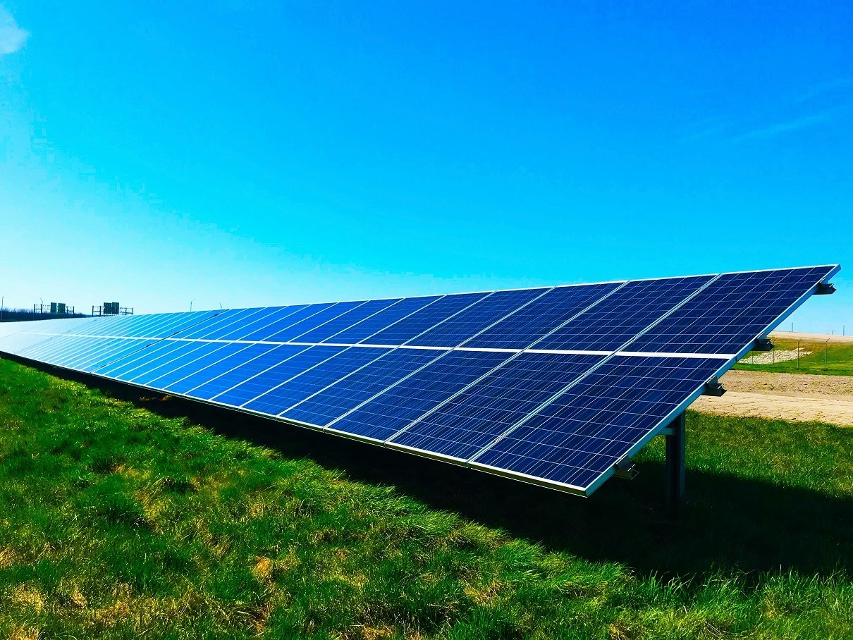 Ground level solar panel installation in field of grass