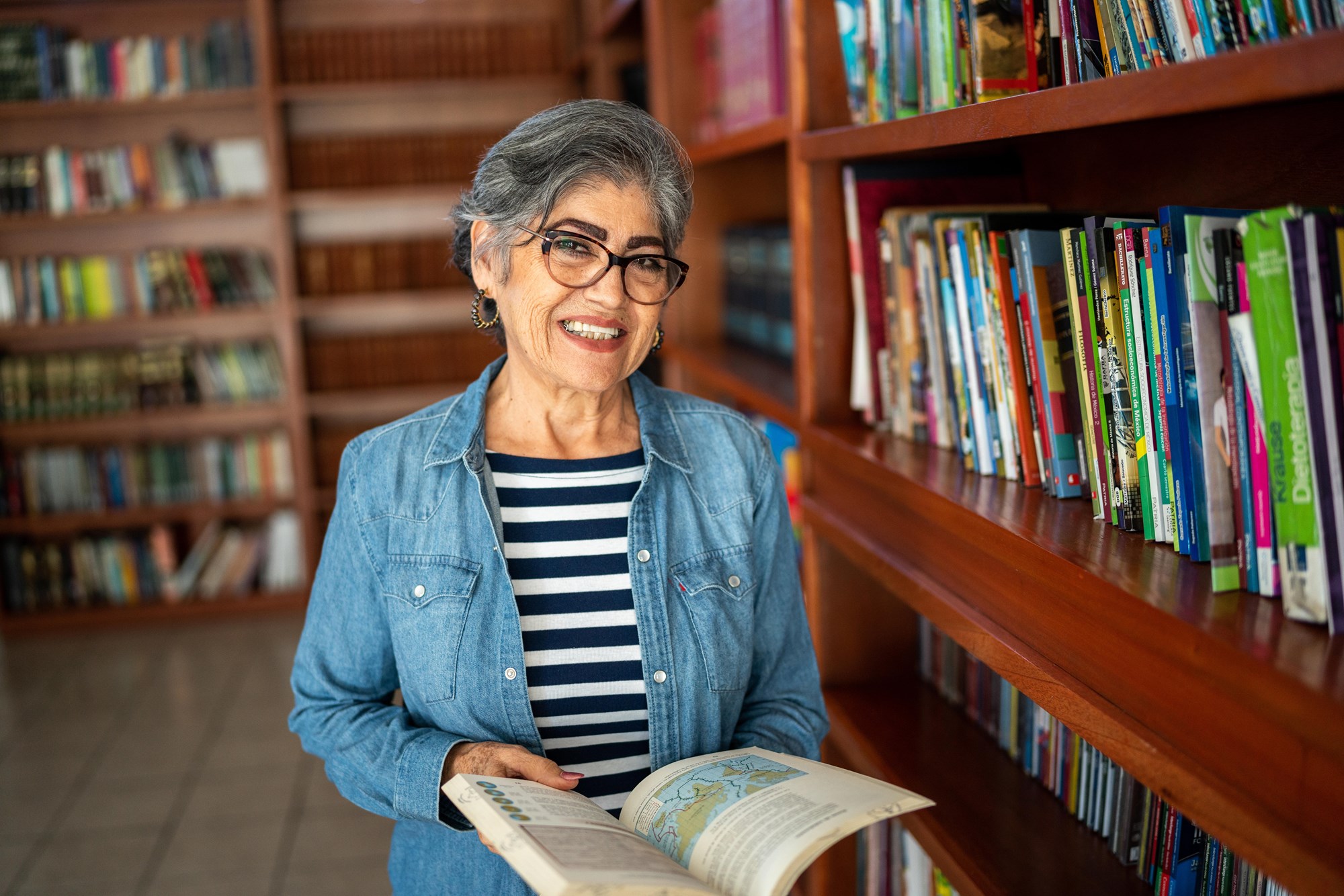 Woman Holding Book in Library