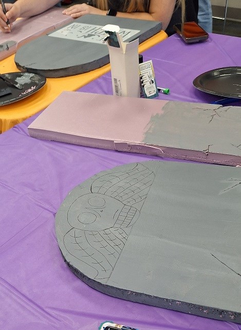 Craft table with library users making model tombstones