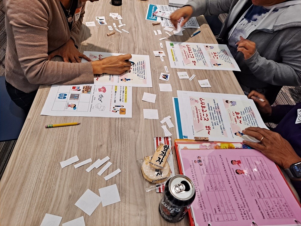 People sitting at table in library working on Japanese vocabulary sheets