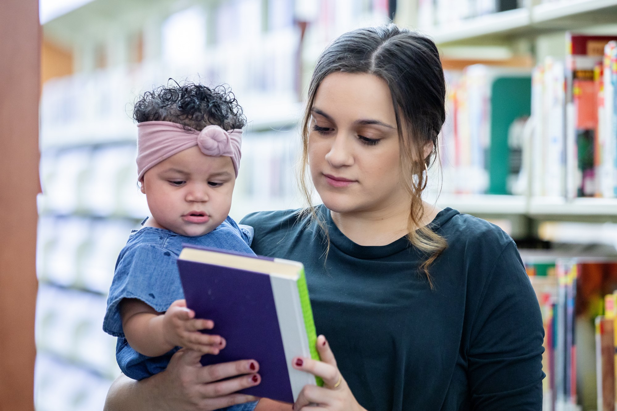 two girls in library reading