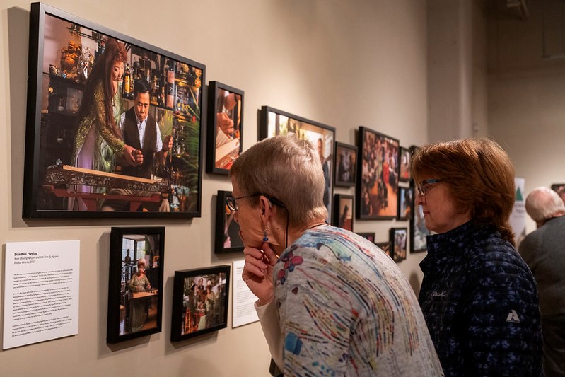 People looking at photographs at the gallery opening of Real Folk: Passing on Trades and Traditions at the Birthplace of Country Music Museum in Bristol, Virginia on Thursday, 3/5/20. 