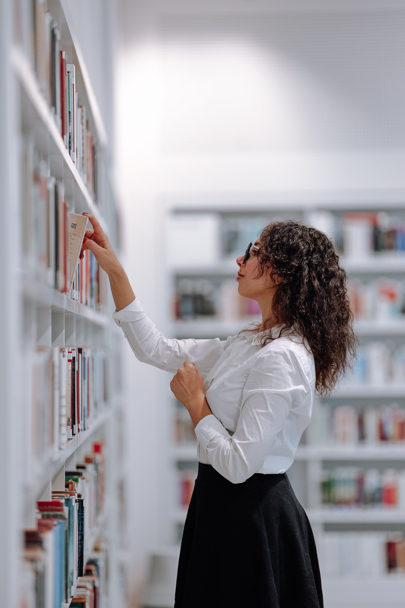 Woman Browsing Books at Stuttgart Library