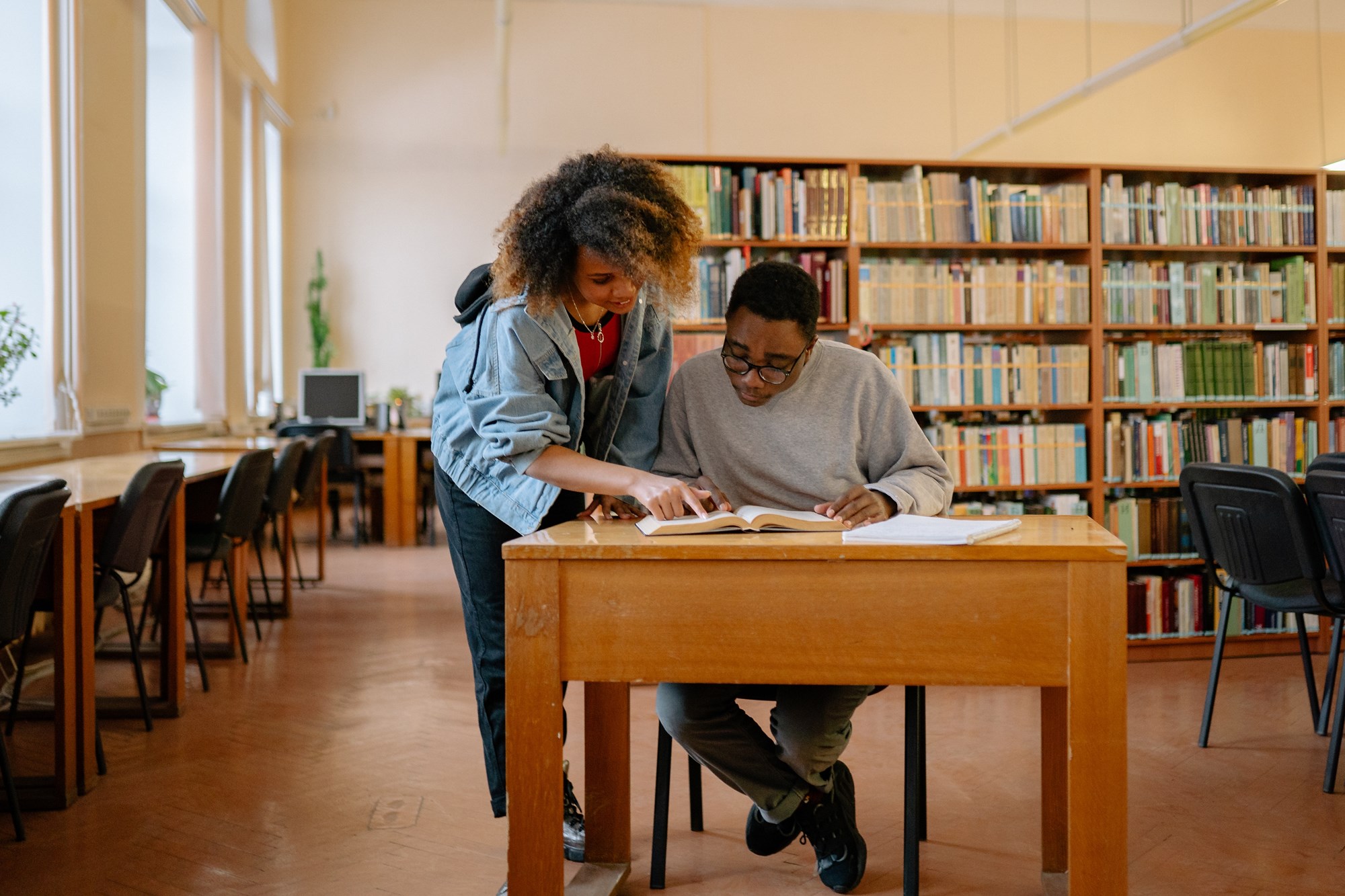 two girls in library reading