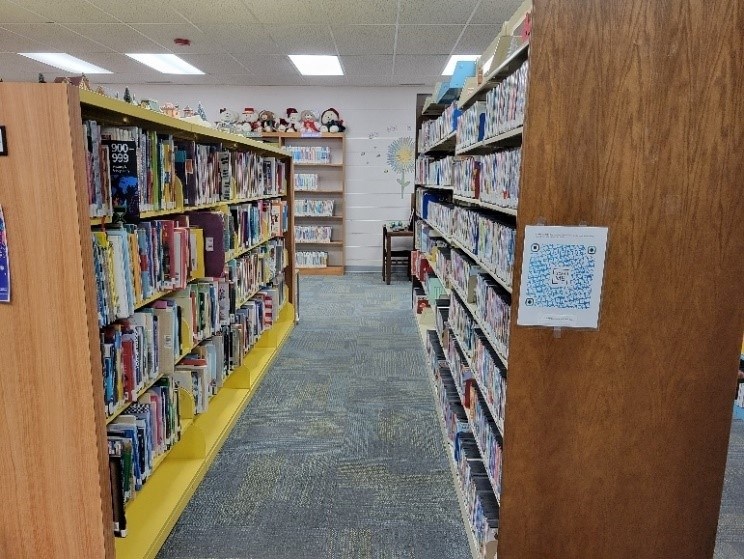 Looking down a row of library bookshelves