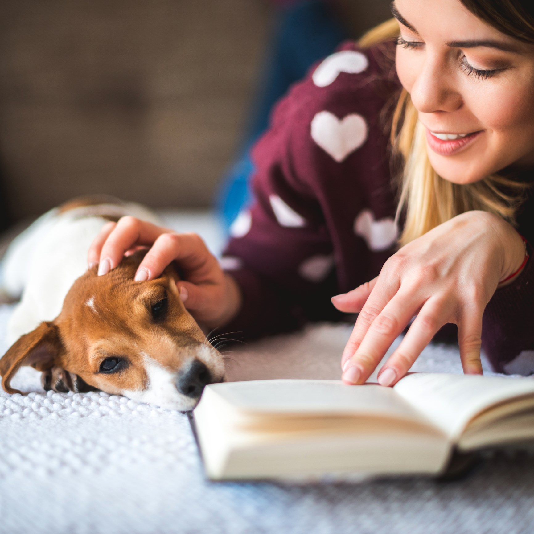 Woman Cuddling with Her Dog Reading