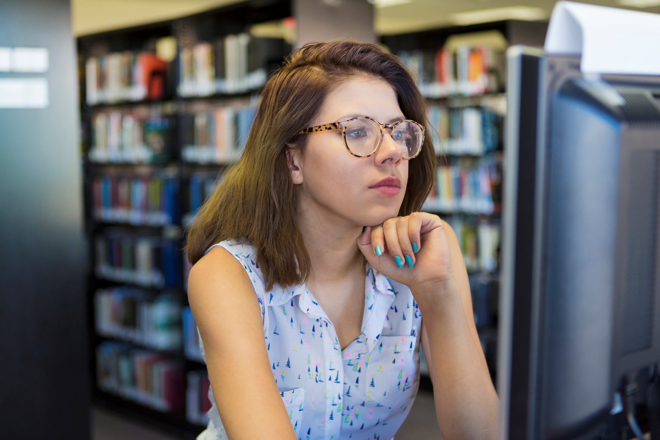 Woman Using Computer in Library